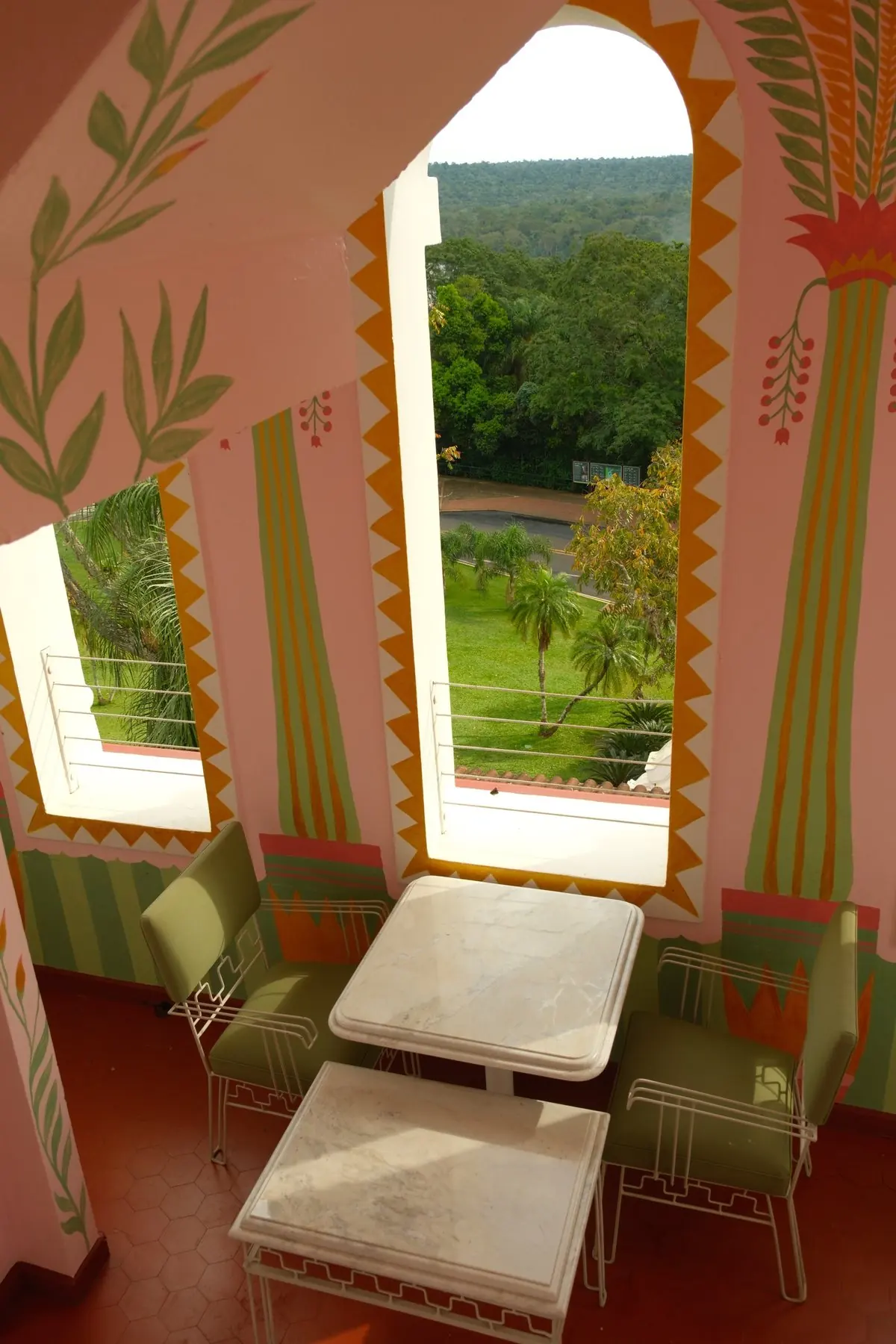 Hand-painted pink walls, marble tables and arched windows over the gardens in the hotel tower