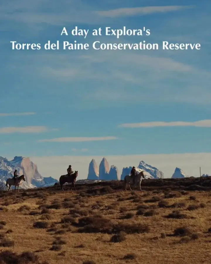 Reel cover: riders crossing the steppe below the Torres del Paine, titled A day at Explora’s Torres del Paine Conservation Reserve