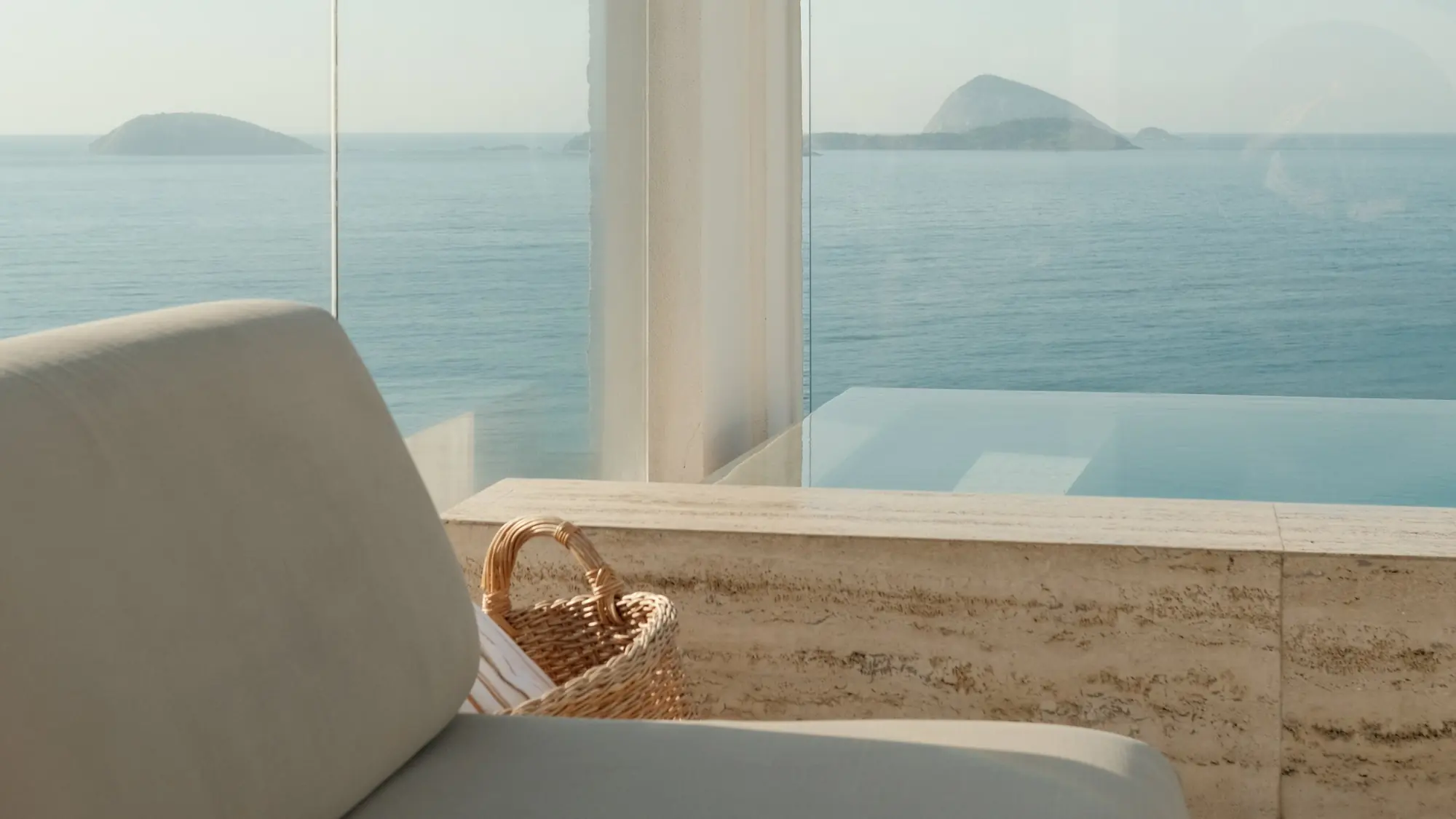 Dois Irmãos rising above a white terrace wall set with Rio’s wave-pattern tiles